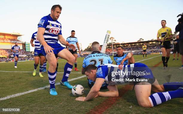 Josh Morris of the Bulldogs goes to his brother Brett after Brett scored a try during the round 11 NRL match between the Cronulla Sharks and the...