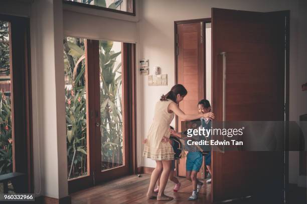 asian chinese family children coming back from school - arriving home stock pictures, royalty-free photos & images