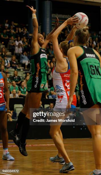 Stacey Francis of the West Coast Fever jumps up high to defend Helen Housby of the NSW Swifts shot on goal during the round four Super Netball match...