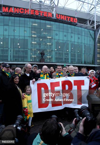 Manchester United fans, wearing green and gold scarves, protest against the Glazers, current owners of Manchester United before the Barclays Premier...