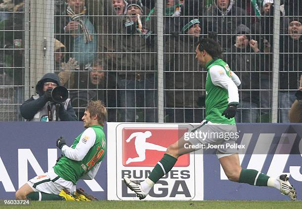 Aaron Hunt of Bremen celebrates with his team mate Hugo Almeida after scoring his team's first goal during the Bundesliga match between Werder Bremen...