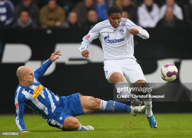 Milos Maric of Bochum tackles Jefferson Farfan of Schalke during the Bundesliga match between VfL Bochum and FC Schalke 04 at Rewirpower Stadium on...