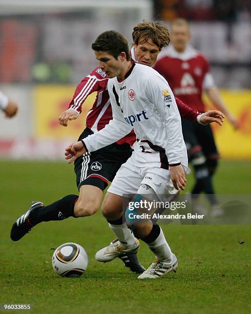 Andreas Ottl of 1. FC Nuernberg fights for the ball with Pirmin Schwegler of Eintracht Frankfurt at Easy Credit Stadium on January 23, 2010 in...