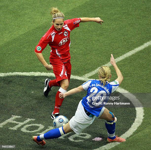 Babett Peter of 1. FFC Turbine Potsdam battles for the ball with Noemie Beney of 1. FC Saarbruecken during the semi-final match of the T-Home DFB...