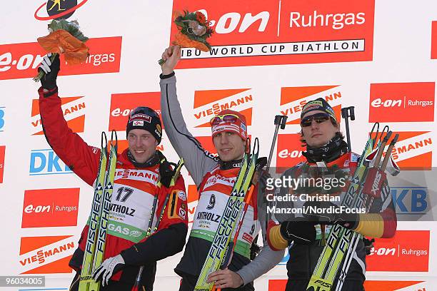 Domink Landertinger of Austria celebrates with Winner Arnd Peiffer of Germany and Christoph Stephan of Germany after the men's sprint in the e.on...