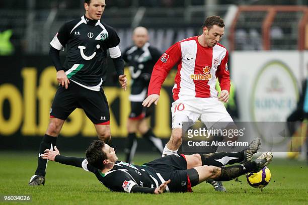 Jan Simak of Mainz is challenged by Hanno Balitsch of Hannover during the Bundesliga match between FSV Mainz 05 and Hannover 96 at the Bruchweg...