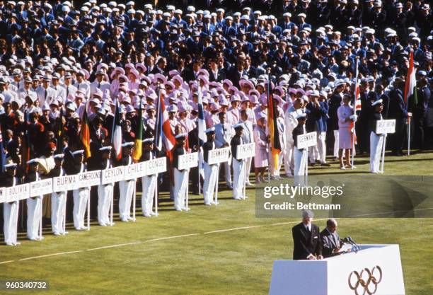 Closeup of teams on the field during the Opening Ceremonies for the XVIII Olympiad.