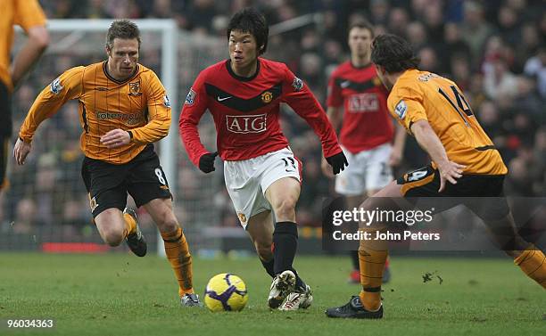 Ji-Sung Park of Manchester United clashes with Nick Barmby and Ricardo Garcia of Hull City during the FA Barclays Premier League match between...