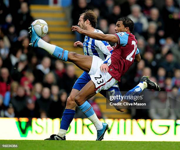 Habib Beye of Aston Villa clears under pressure from Glenn Murray of Brighton during the FA Cup sponsored by E.ON 4th Round match between Aston Villa...