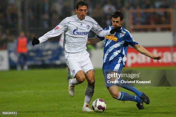 Mergim Mavraj of Bochum tackles Kevin Kuranyi of Schalke during the Bundesliga match between VfL Bochum and FC Schalke 04 at Rewirpower Stadium on...