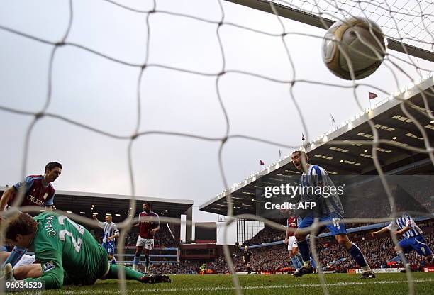 Brighton & Hove Albion's English striker Glenn Murray reacts as the ball hits the net past Aston Villa's USA goalkeeper Brad Guzan after Brighton's...