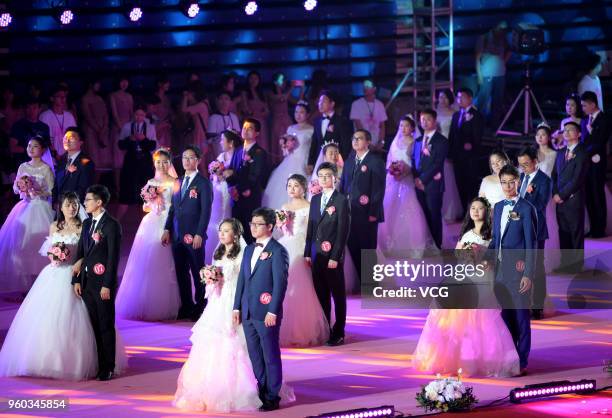 Fifty-six couples participate in the group wedding ceremony for alumni at Northeastern University on May 20, 2018 in Shenyang, Liaoning Province of...