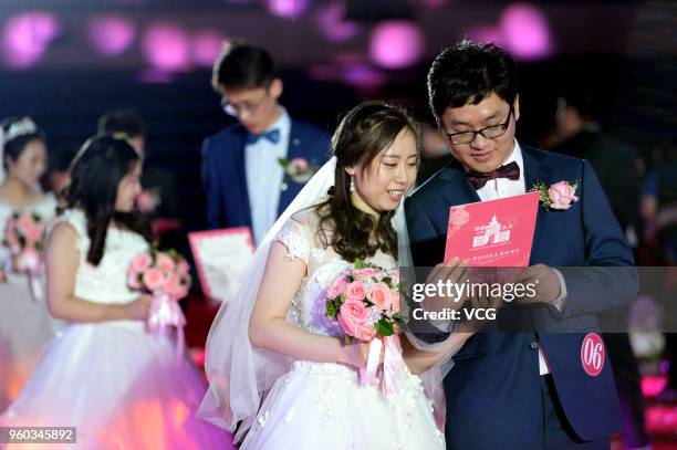 Fifty-six couples participate in the group wedding ceremony for alumni at Northeastern University on May 20, 2018 in Shenyang, Liaoning Province of...