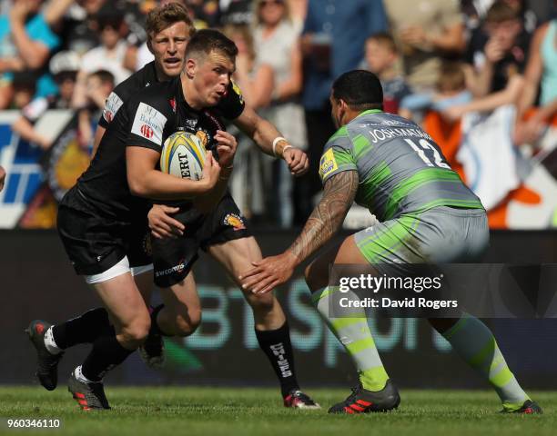 Joe Simmonds of Exeter takes on Josh Matavesi during the Aviva Premiership Semi Final between Exeter Chiefs and Newcastle Falcons at Sandy Park on...