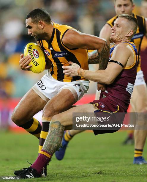 Shaun Burgoyne of the Hawks is tackled by Dayne Beams of the Lions during the 2018 AFL round nine match between the Brisbane Lions and the Hawthorn...