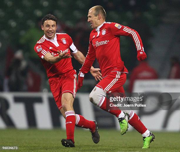 Arjen Robben of Bayern celebrates with his team mate Mark van Bommel after scoring his team's third goal during the Bundesliga match between Werder...