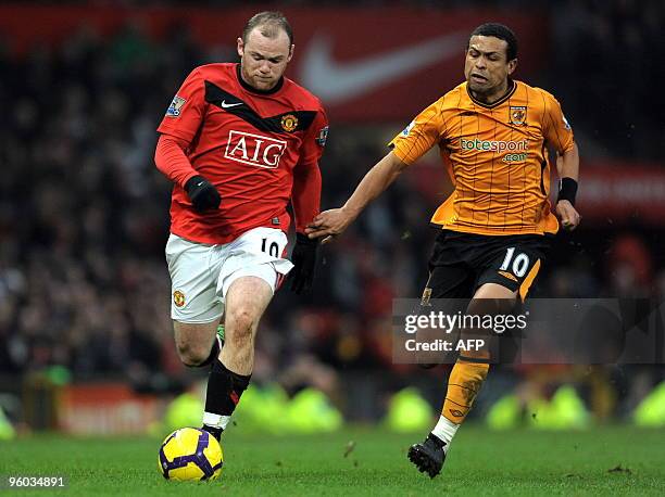 Hull City's Brazilian midfielder Geovanni vies with Manchester United's English forward Wayne Rooney during the English Premier League football match...