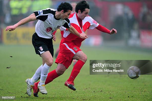 John Miles of Accrington Stanley is challenged by Stephen Kelly of Fulham during the FA Cup Sponsored by E.ON 4th Round match between Accrington...