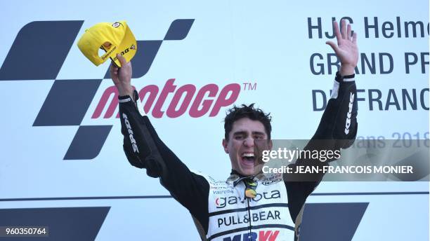 Angel Nieto Team Moto3 Spanish rider Albert Arenas celebrates on the podium after winning a Moto3 race of the French Motorcycle Grand Prix on May 20,...