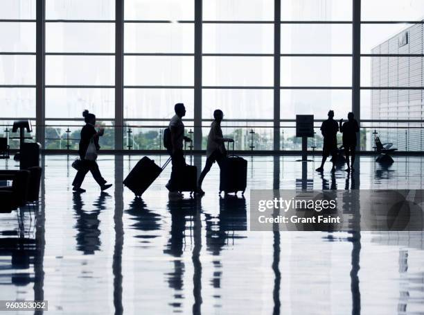 view of airport departures area travellers rushing. - airport passenger foto e immagini stock