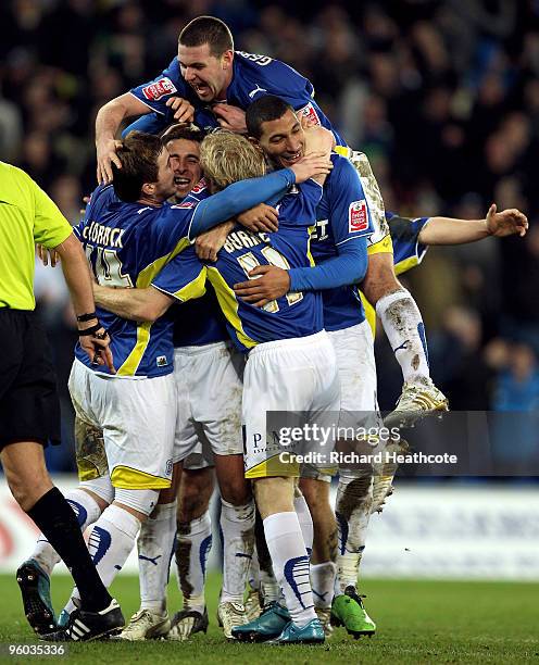 Cardiff City players celebrate as Chris Burke scores the third goal during the FA Cup 4th Round match between Cardiff City and Leicester City at the...