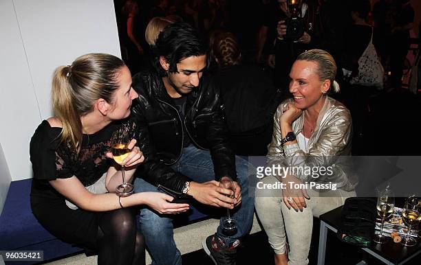 Natascha Ochsenknecht and her friend Umut Kekilli talk to a guest at the Michalsky Style Night during the Mercedes-Benz Fashion Week Berlin...