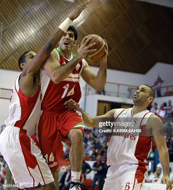 Omar Turk and CJ Giles of Lebanon's Al-Riyadi Sporting club challenge Mohammadsamad Bahrami of Iran's Mahram club as he goes for the basket during...