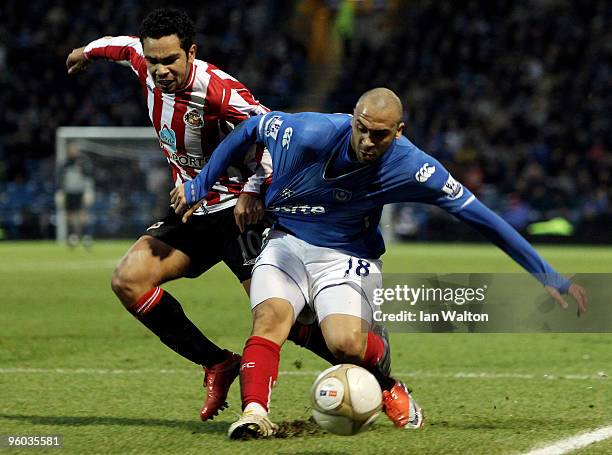 Kieran Richardson of Sunderland tries to tackle Anthony Vaden Borre of Portsmouth during the FA Cup 4th Round sponsored by E.on match between...