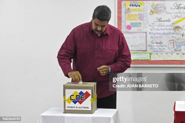 Venezuelan President Nicolas Maduro casts his vote during the presidential elections in Caracas on May 20, 2018. Venezuelans headed to the polls...