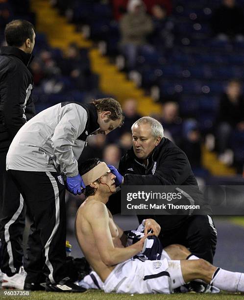 Jonas Olsson of West Bromwich Albion has treatment for a head wound during the FA Cup sponsored by E.O.N 4th Round match between West Bromwich Albion...