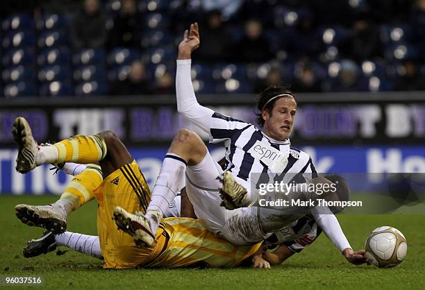 Jonas Olsson of West Bromwich Albion tangles with Shola Ameobi of Newcastle United during the FA Cup sponsored by E.O.N 4th Round match between West...