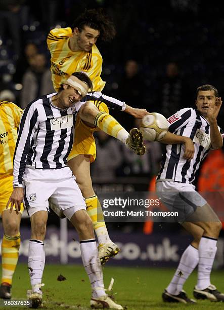 Jonas Olsson of West Bromwich Albion tangles with Andrew Carroll of Newcastle United during the FA Cup sponsored by E.O.N 4th Round match between...