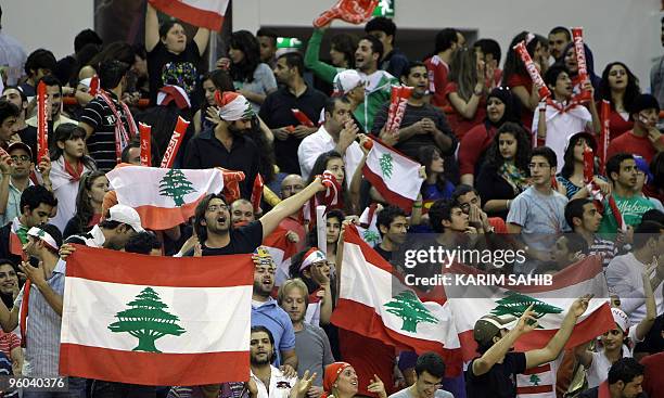 Fans of Lebanon's Al-Riyadi Sporting club cheer for their team during their Dubai International Basketball Tournament final match against Iran's...