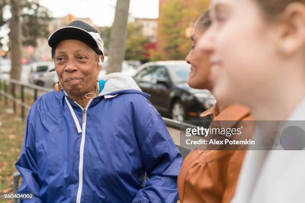 two black women and white teenager girl hanging in the square in bronx - bronx street stock pictures, royalty-free photos & images