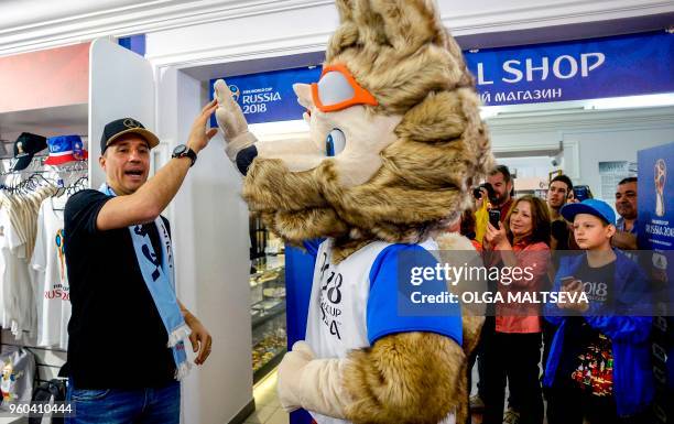 Hernan Crespo, former striker of the Argentina national football team poses with mascot Zabivaka as he visits an official FIFA World Cup 2018 shop in...