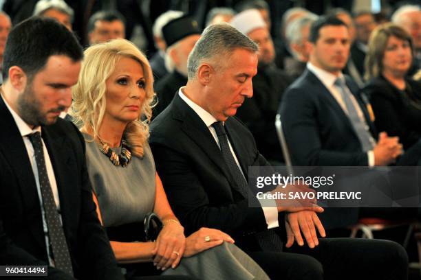 Six-time prime minister Milo Djukanovic , flanked by his wife Lidija, waits to be sworn in as Montenegro's President during a ceremony in Cetinje on...