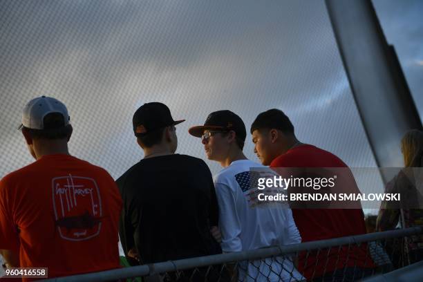 Fans of the Santa Fe HS baseball team attend a makeup game a day after the mass shooting May 19, 2018 in Deer Park, Texas. - Ten people, mostly...