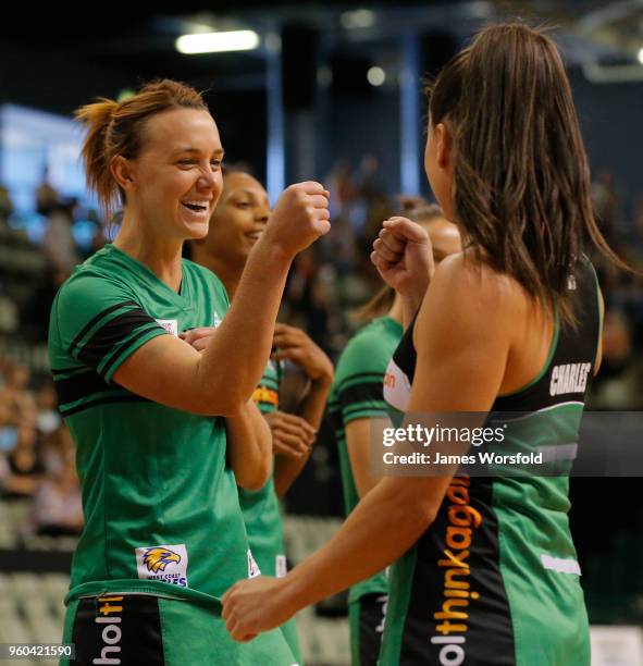 Natalie Medhurst of the West Coast Fever high fives her teammates as they run out onto the court before the Super Netball match between the Fever and...