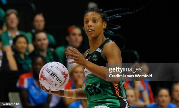 Stacey Francis of the West Coast Fever look the release the ball to a team mate during the Super Netball match between the Fever and the Swifts at...