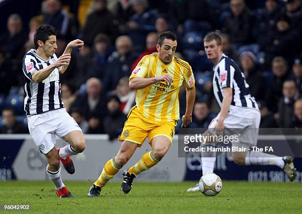 Jose Enrique of Newcastle gets past Robert Koren and Chris Brunt of West Bromwich during the FA Cup sponsored by E.ON 4th Round match between West...