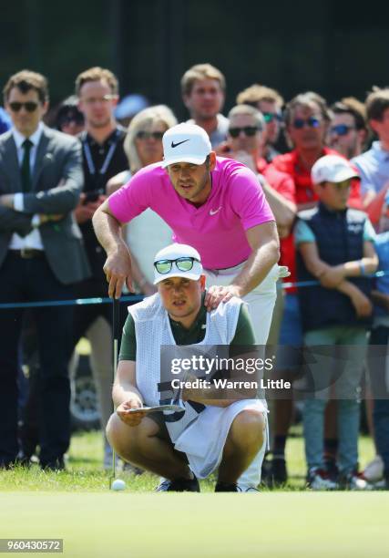 James Heath of England lines up his putt with his caddy on the 9th green during his semi final match against Benjamin Herbert of France during the...