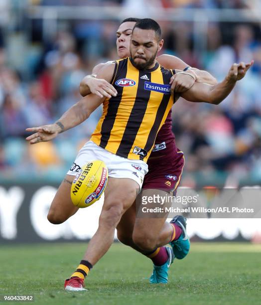 Jarman Impey of the Hawks is tackled by Cameron Rayner of the Lions during the 2018 AFL round nine match between the Brisbane Lions and the Hawthorn...