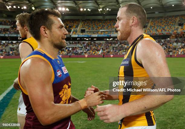 Luke Hodge of the Lions and Jarryd Roughead of the Hawks embrace after the 2018 AFL round nine match between the Brisbane Lions and the Hawthorn...