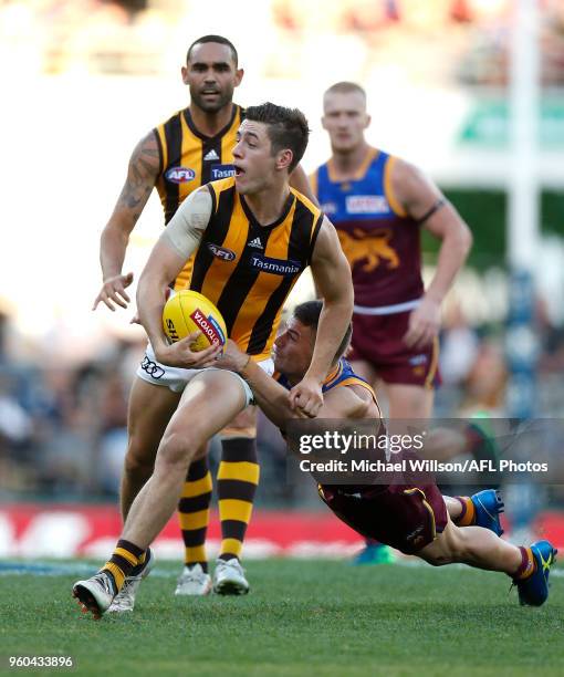 James Cousins of the Hawks is tackled by Dayne Zorko of the Lions during the 2018 AFL round nine match between the Brisbane Lions and the Hawthorn...