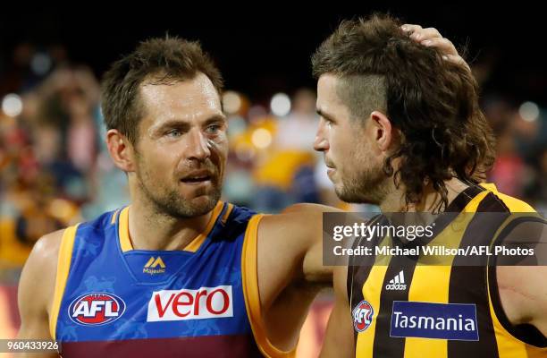 Luke Hodge of the Lions and Ben Stratton of the Hawks embrace after the 2018 AFL round nine match between the Brisbane Lions and the Hawthorn Hawks...