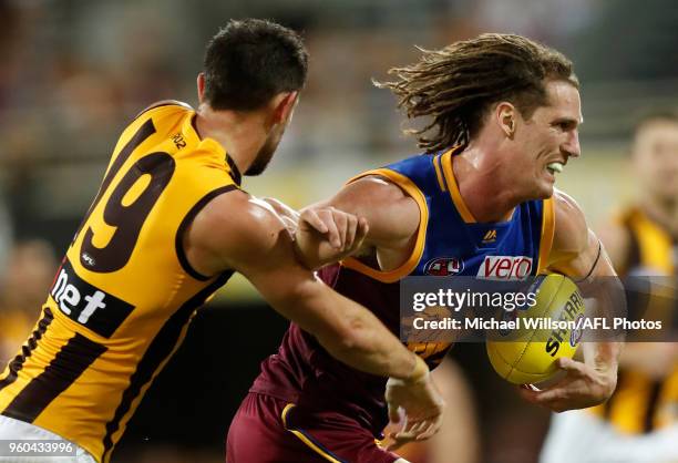 Matt Eagles of the Lions is tackled by Jack Gunston of the Hawks during the 2018 AFL round nine match between the Brisbane Lions and the Hawthorn...