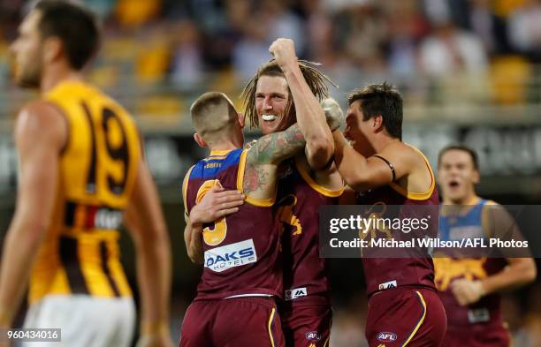 Dayne Beams, Matt Eagles and Hugh McCluggage of the Lions celebrate during the 2018 AFL round nine match between the Brisbane Lions and the Hawthorn...