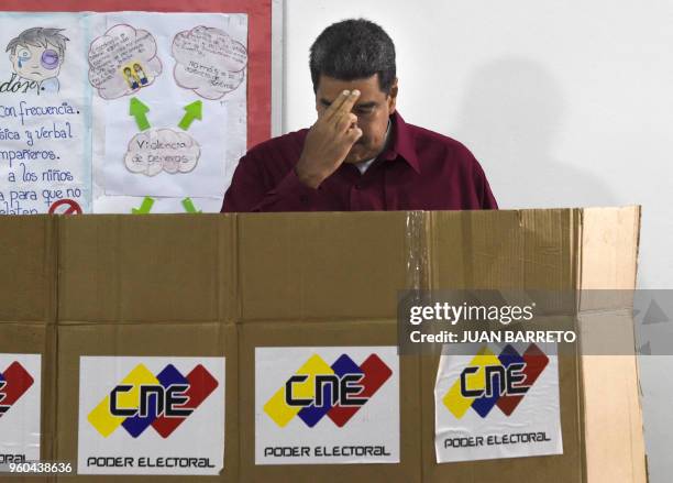 Venezuelan President Nicolas Maduro casts his vote during the presidential elections in Caracas on May 20, 2018. Venezuelans headed to the polls...