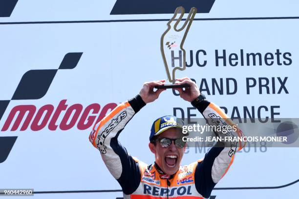 Repsol Honda Team's Spanish rider Marc Marquez celebrates on the podium with the trophy after winning the MotoGP race, of the French motorcycling...