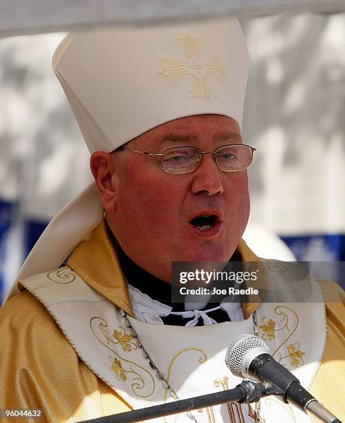 Archbishop Timothy Dolan, Archbishop of New York and Chairman of the Board of Catholic Relief Services, speaks at the collapsed Notre Dame Cathedral...